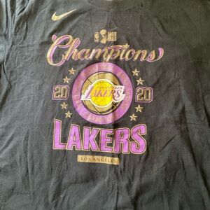 5-2026 ..Nike Black Lakers Champions Tee with Purple and Gold Accents.SIZE 2XL